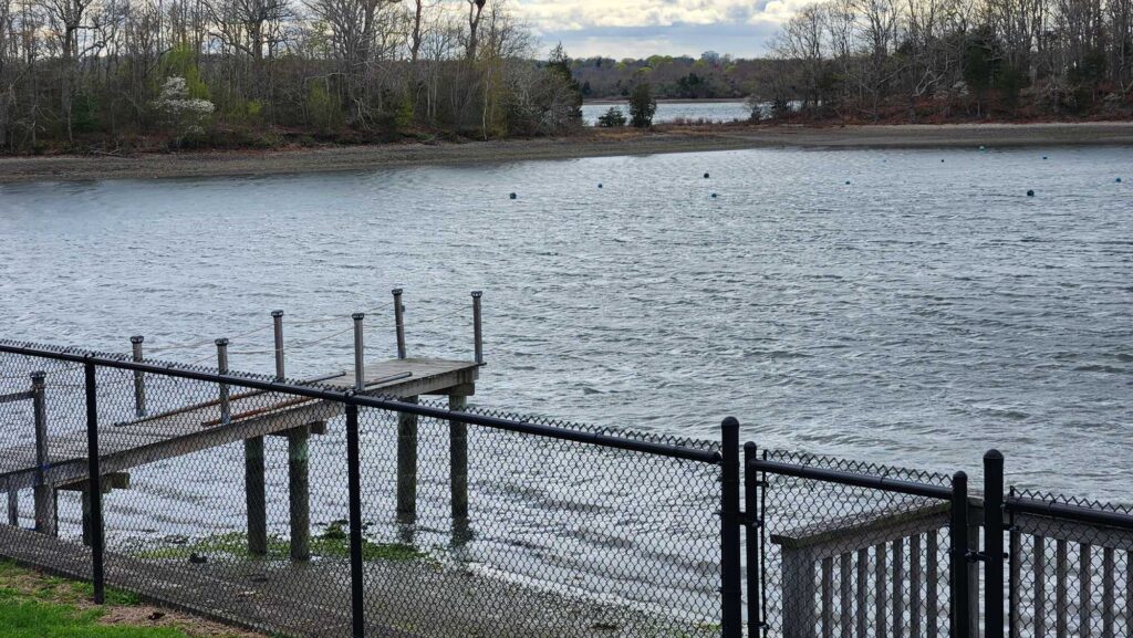 a body of water with a fence and a metal railing (MyCoast AI)