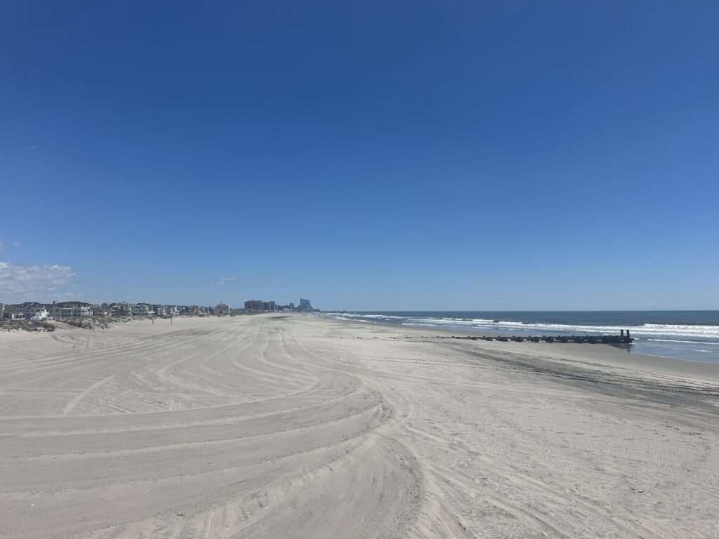 a sandy beach with waves crashing on it (MyCoast AI)