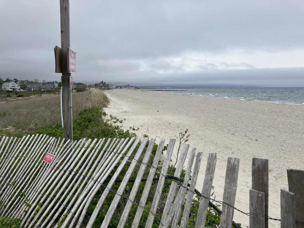 a white fence on a beach (MyCoast AI)