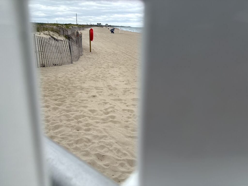 a sandy beach with a fence (MyCoast AI)