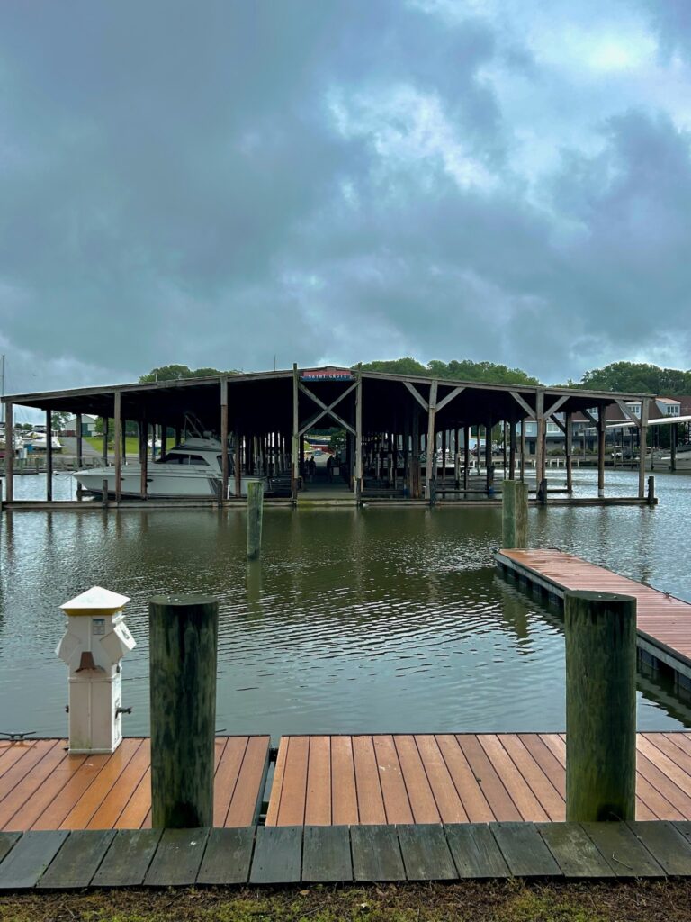 a pier with a body of water and a building in the background (MyCoast AI)