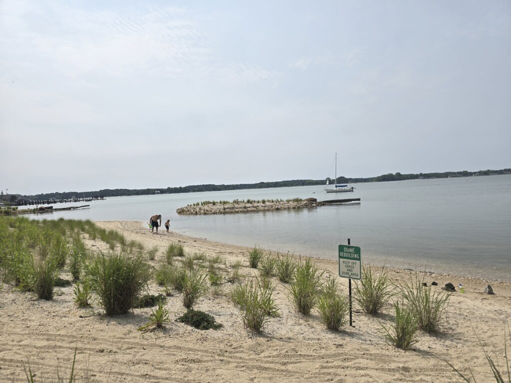 a beach with a boat in the water (MyCoast AI)