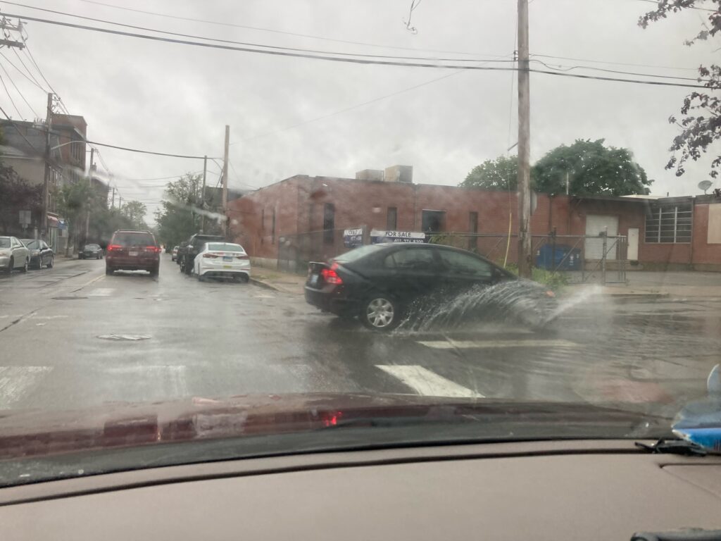 a car driving on a rainy road (MyCoast AI)