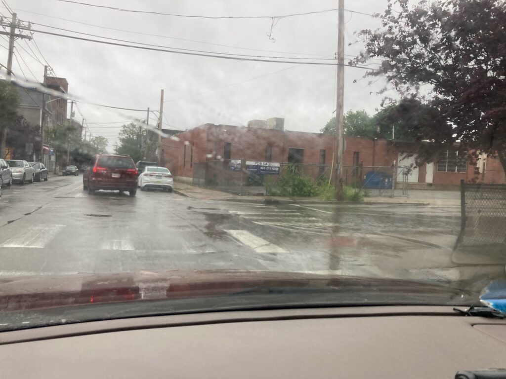 a rainy street with cars (MyCoast AI)