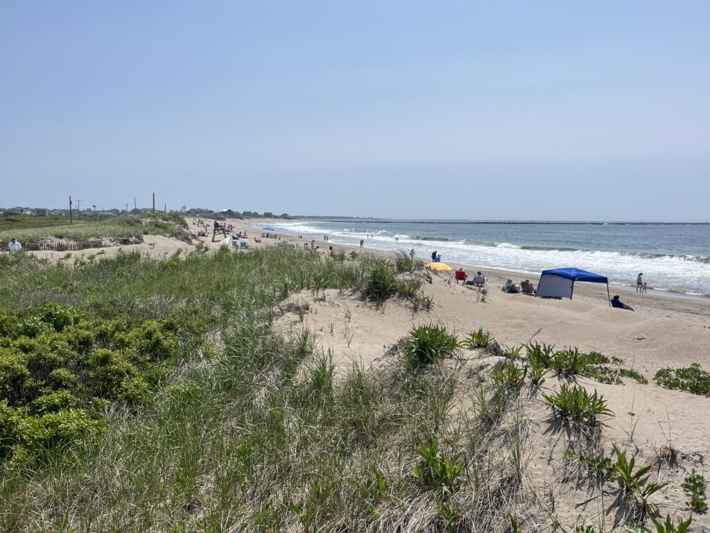 a beach with people and tents (MyCoast AI)