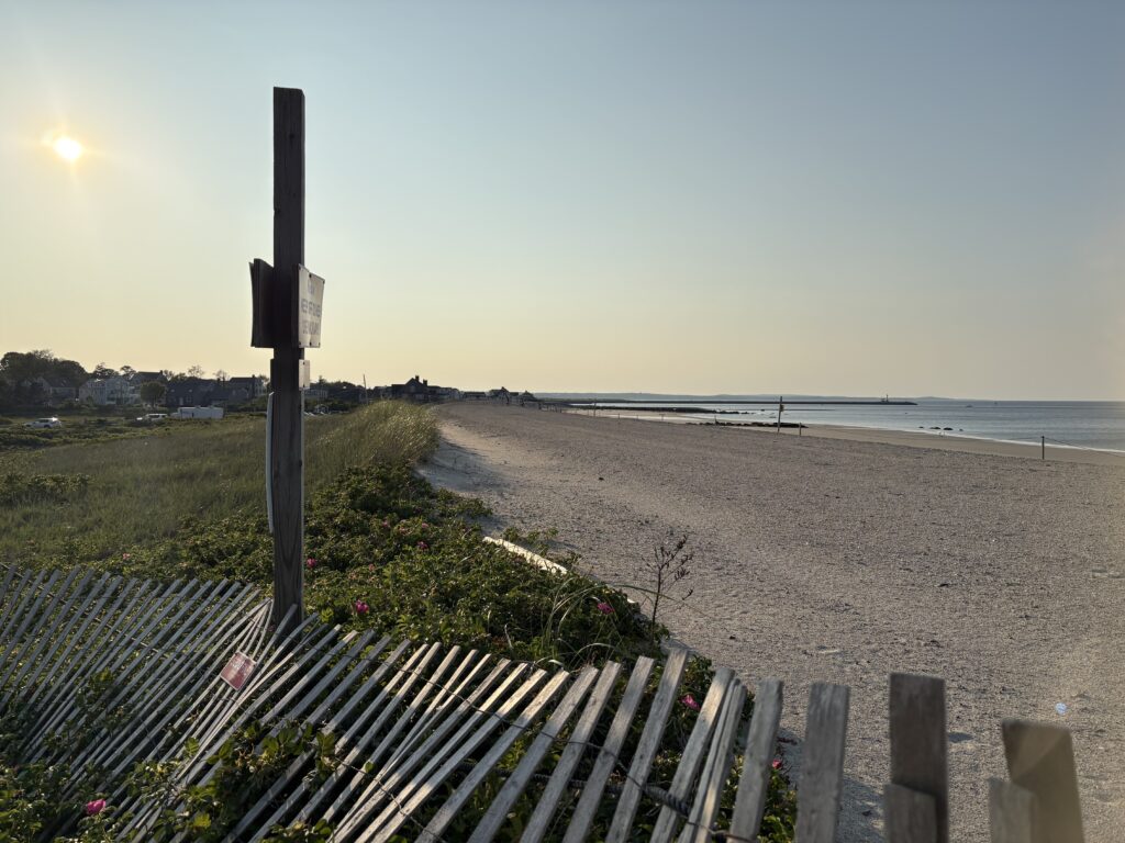 a beach with a fence and a sign (MyCoast AI)