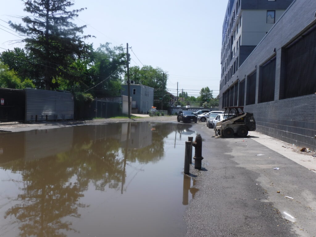 a flooded street with cars parked (MyCoast AI)