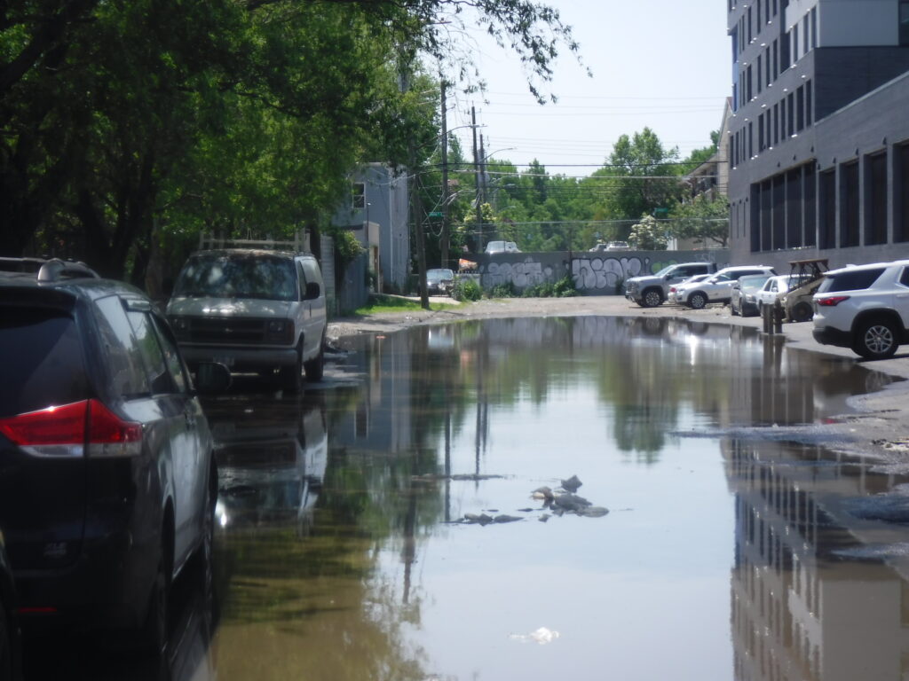 a flooded street with cars and buildings (MyCoast AI)
