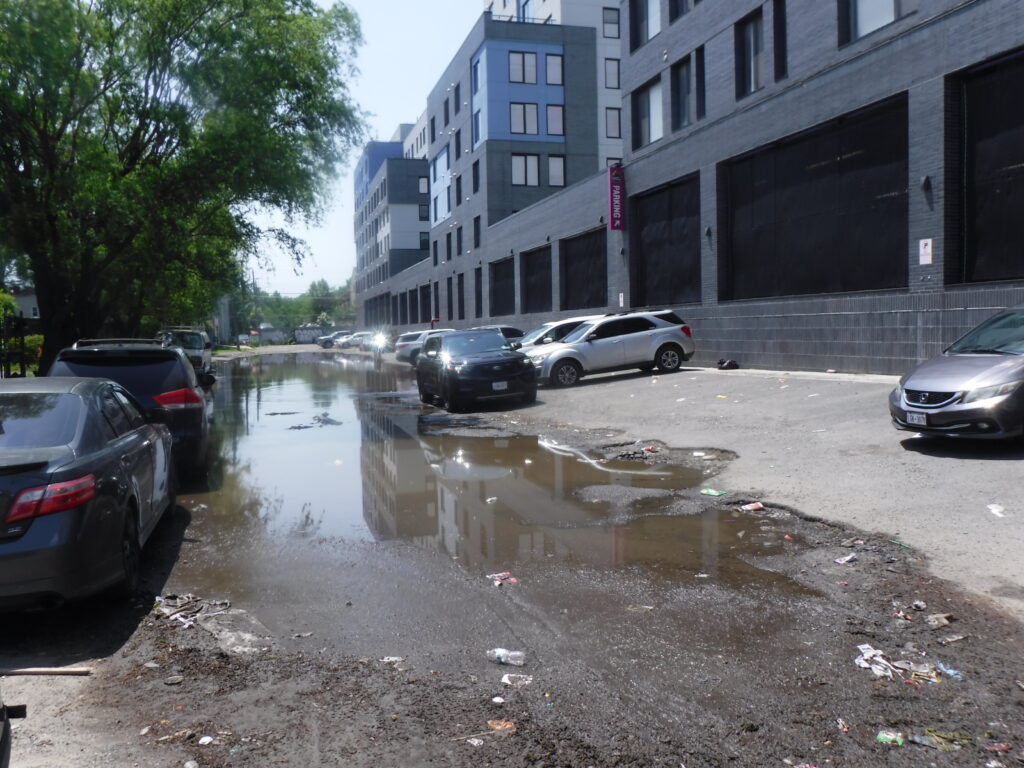 a flooded street with cars parked on the side (MyCoast AI)