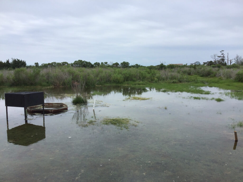 a flooded area with a chair and a table in it (MyCoast AI)