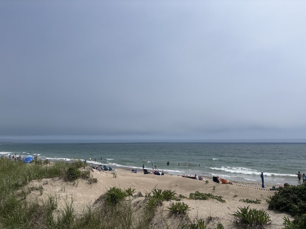 a beach with people and boats (MyCoast AI)