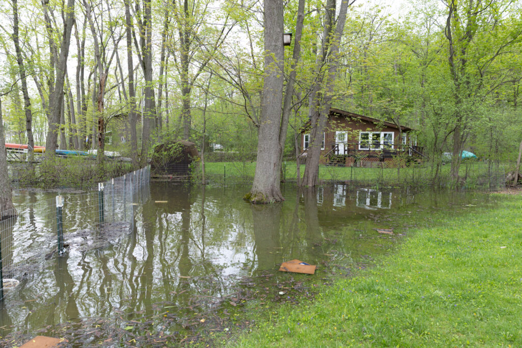 a pond with a house in the background (MyCoast AI)