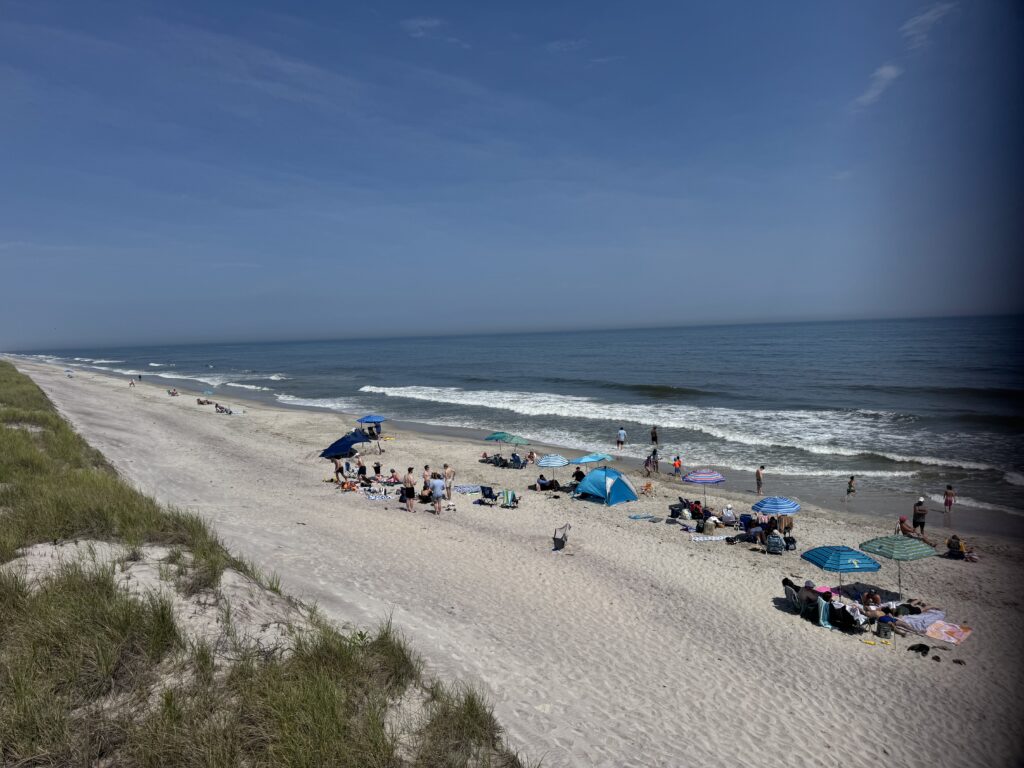 a beach with people and umbrellas (MyCoast AI)