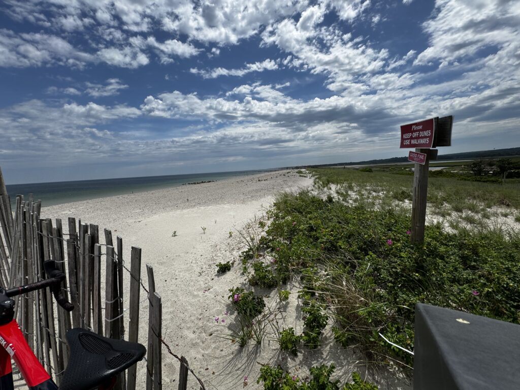 a beach with a fence and a sign (MyCoast AI)