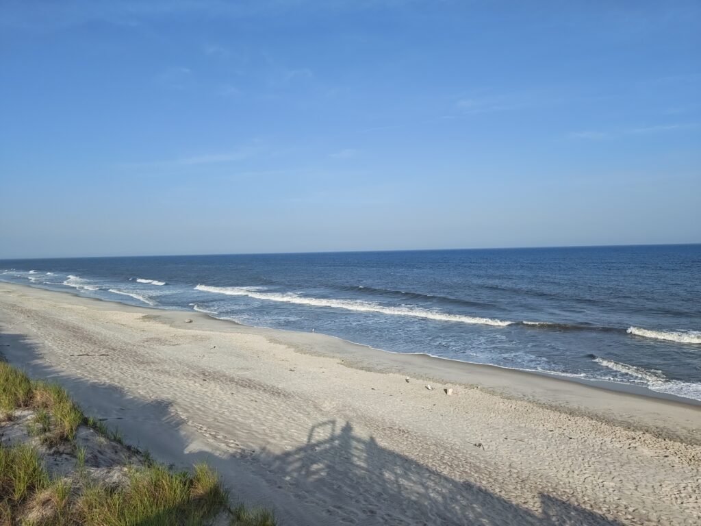 a sandy beach with waves crashing on it (MyCoast AI)