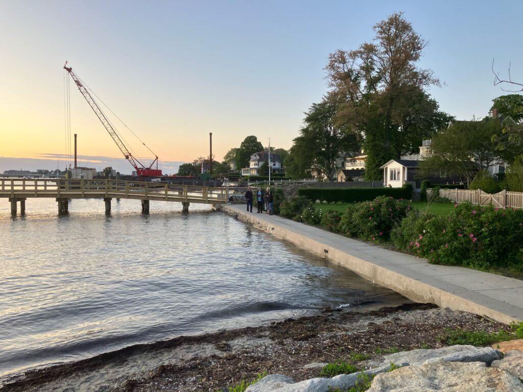 a body of water with a bridge and people walking on it (MyCoast AI)