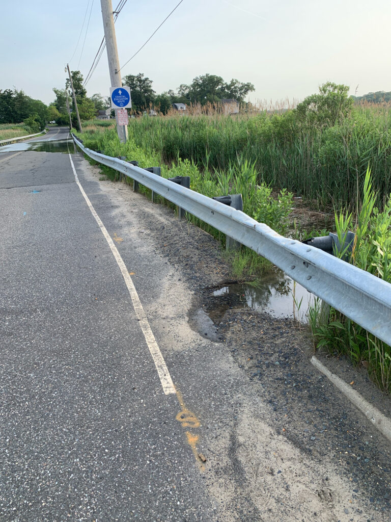 a road with a pipe and grass on the side (MyCoast AI)