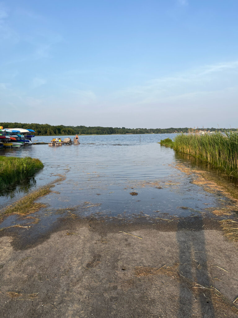 a body of water with boats in it and grass on the side (MyCoast AI)