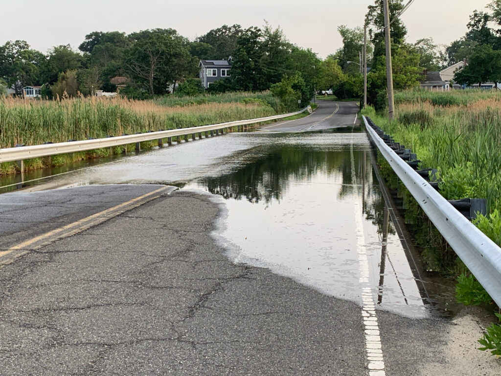 a flooded road with a fence (MyCoast AI)