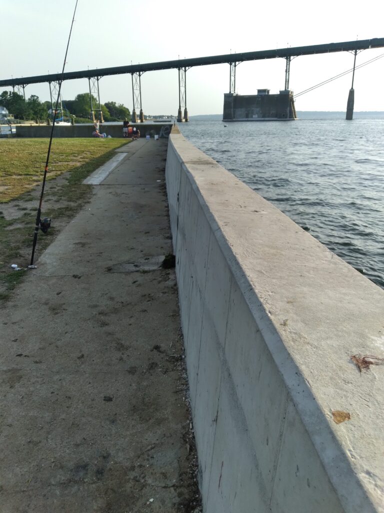 a concrete walkway next to a body of water (MyCoast AI)