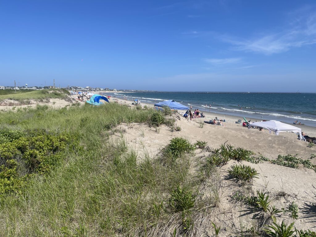 a beach with people and tents (MyCoast AI)