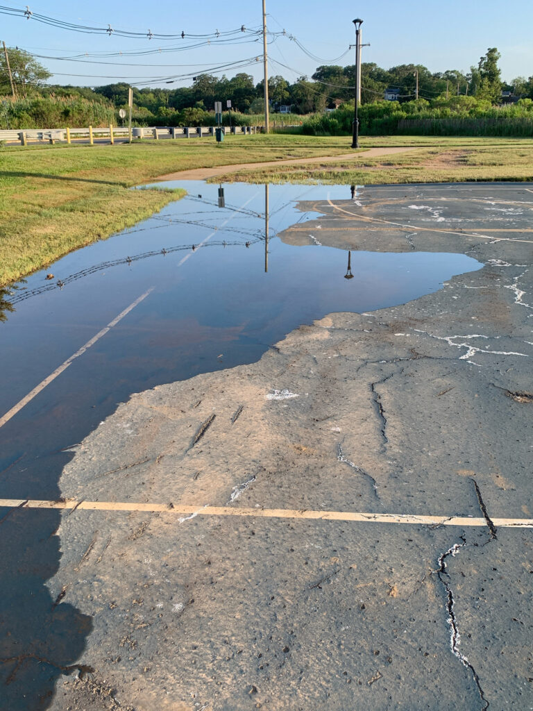a puddle on a road (MyCoast AI)