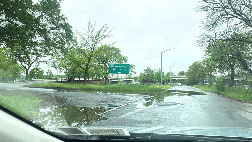 a flooded road with a car driving (MyCoast AI)