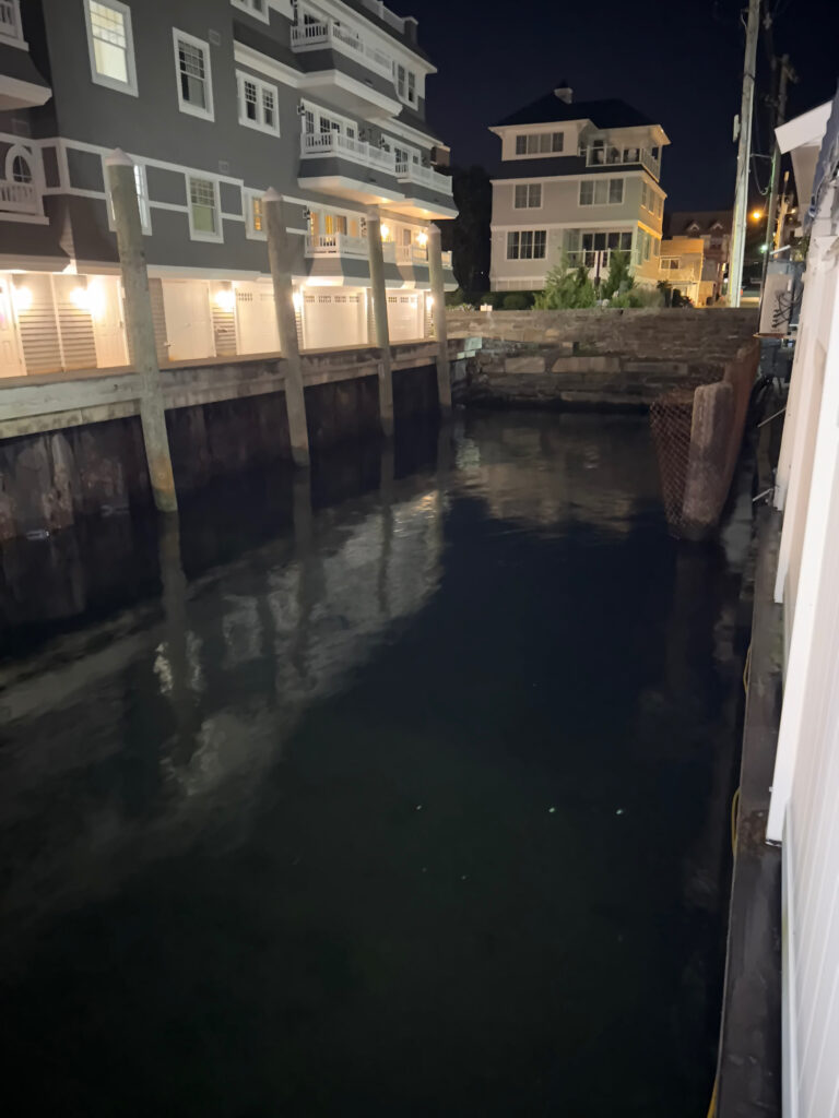 a canal between buildings (MyCoast AI)