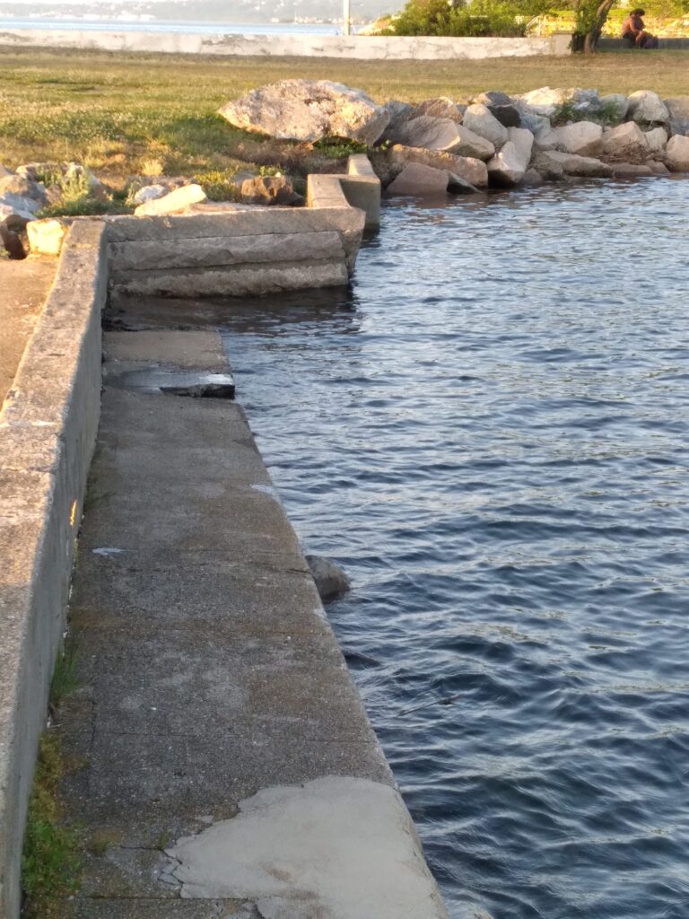 a stone walkway over a body of water (MyCoast AI)