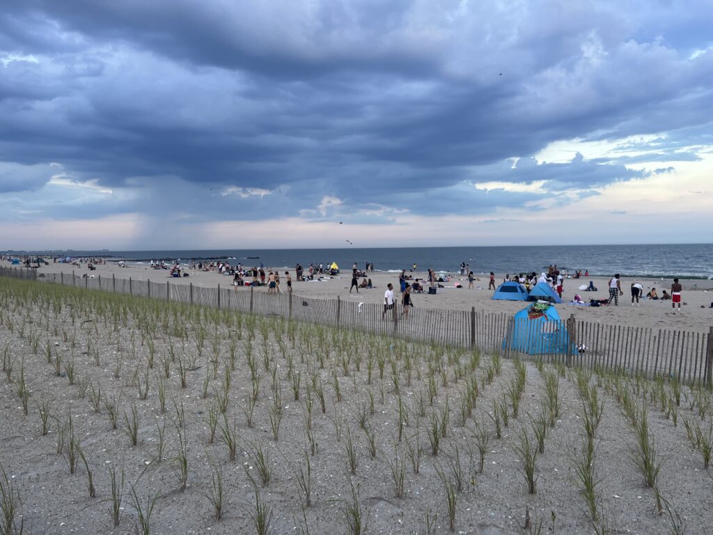 a beach with people and umbrellas (MyCoast AI)