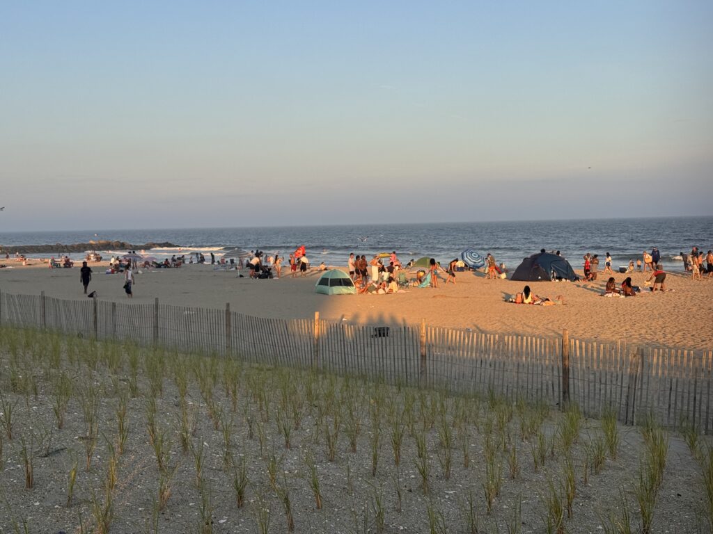 a beach with people and umbrellas (MyCoast AI)