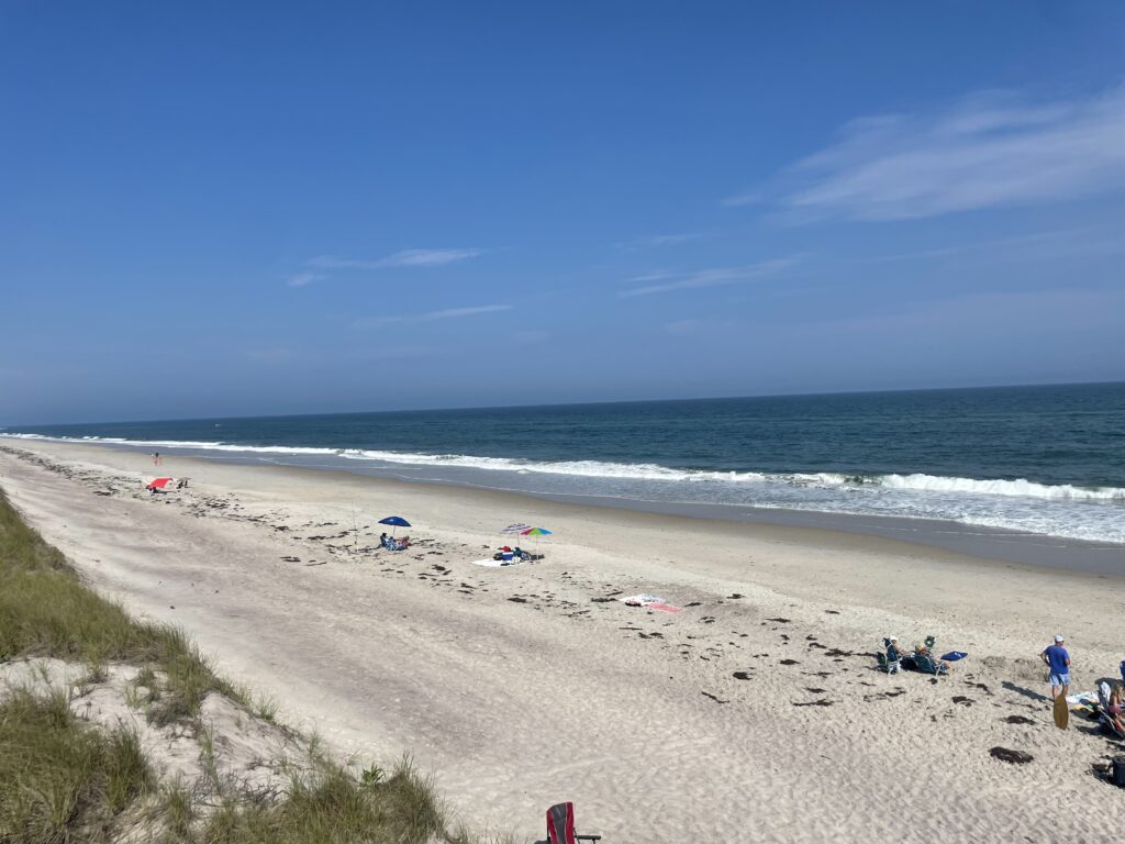 a beach with people and umbrellas (MyCoast AI)
