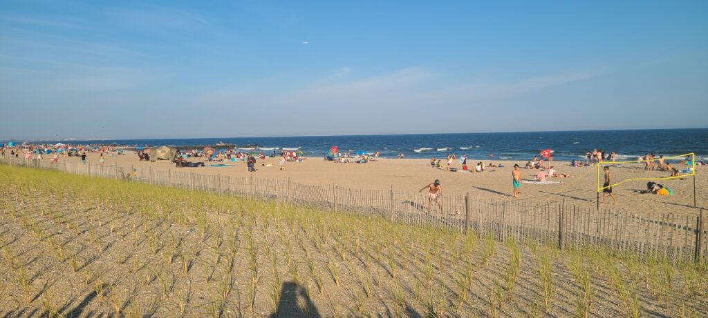 a beach with people and a fence (MyCoast AI)