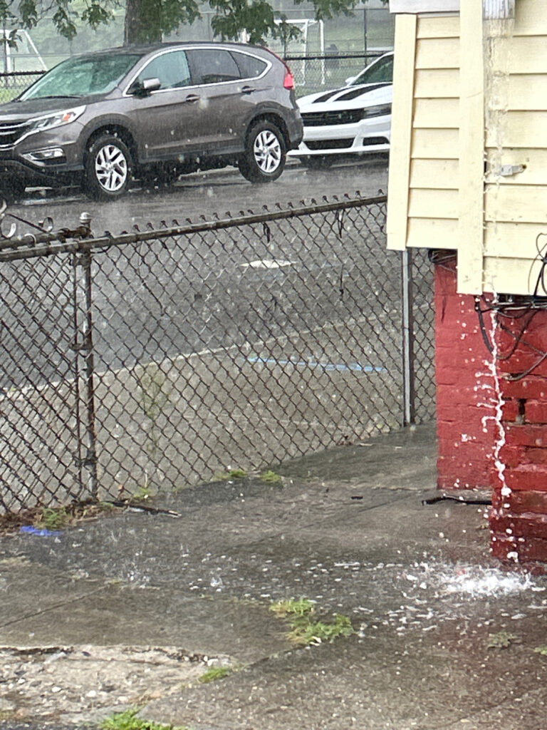 a fence and cars parked in a driveway (MyCoast AI)