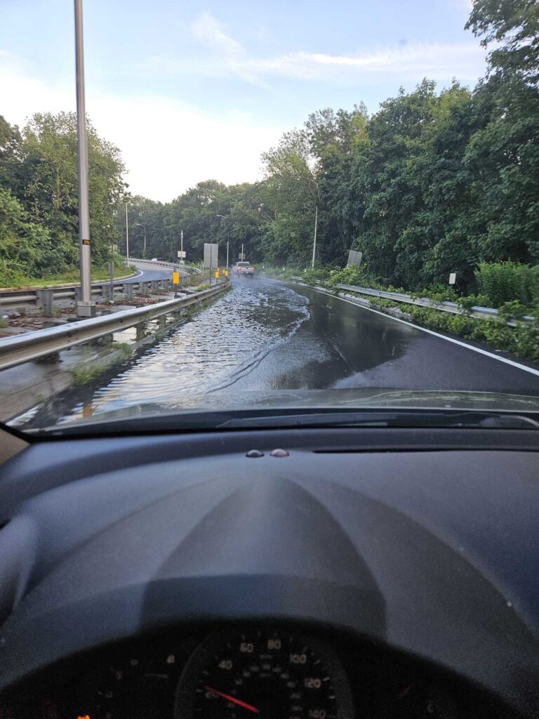 a car driving on a wet road (MyCoast AI)