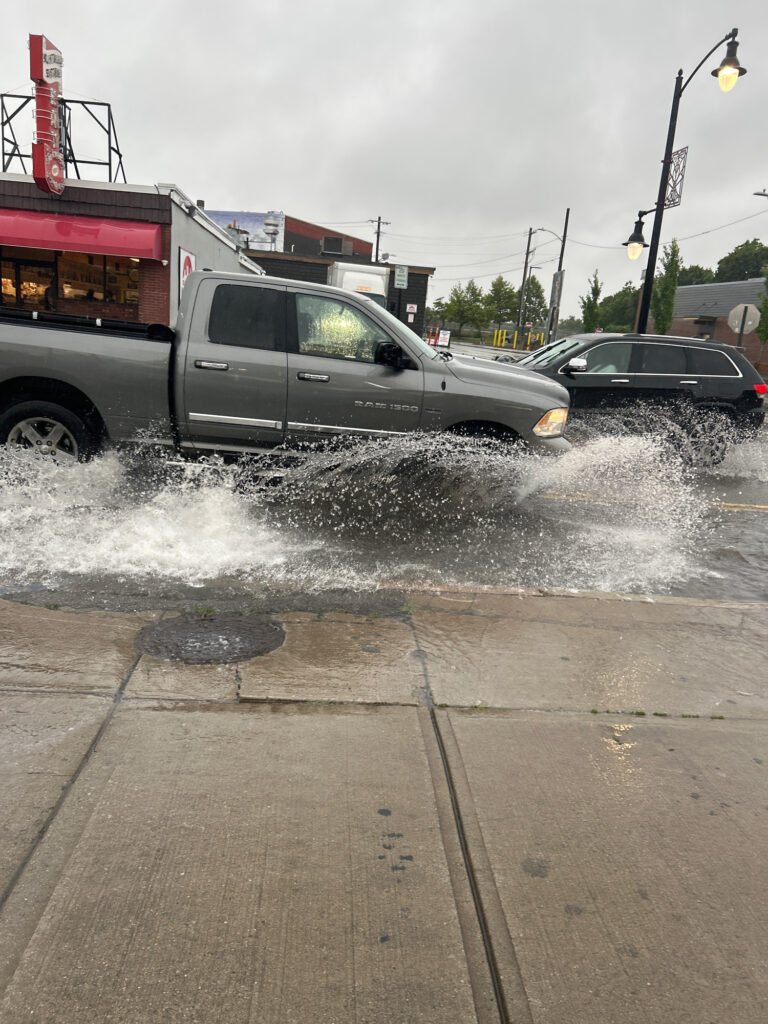 a truck driving through a flooded street (MyCoast AI)