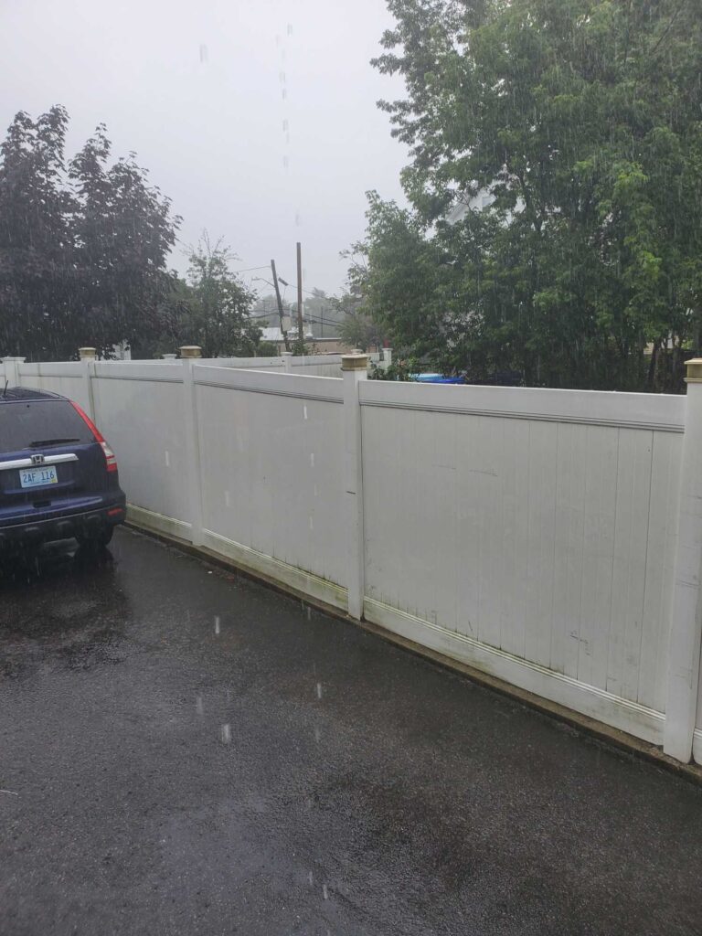 a white wall with a car parked in front of it (MyCoast AI)
