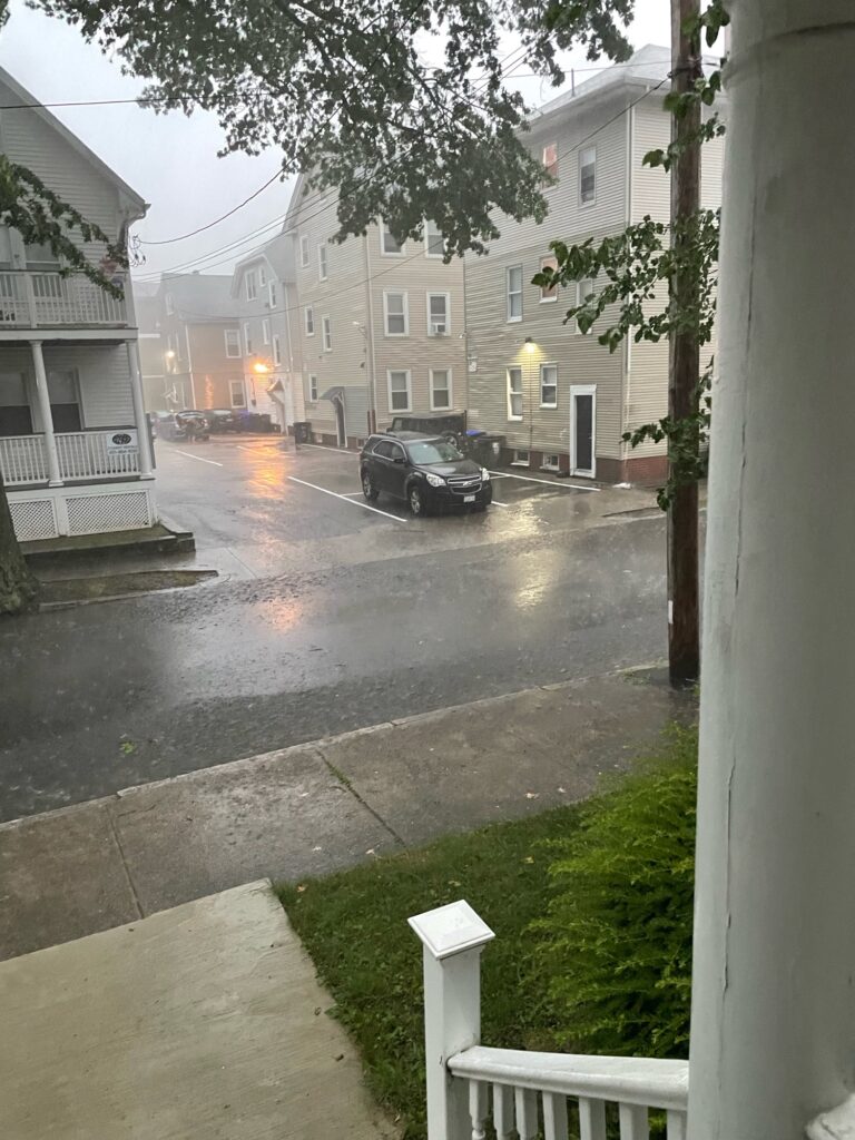 a street with cars on it and buildings on the side (MyCoast AI)