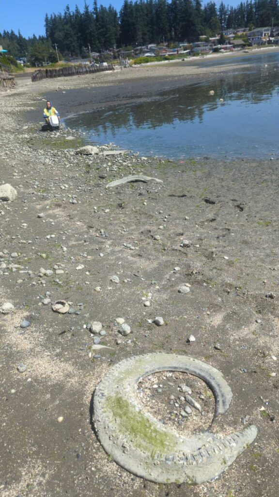 a person sitting on a rock next to a lake (MyCoast AI)