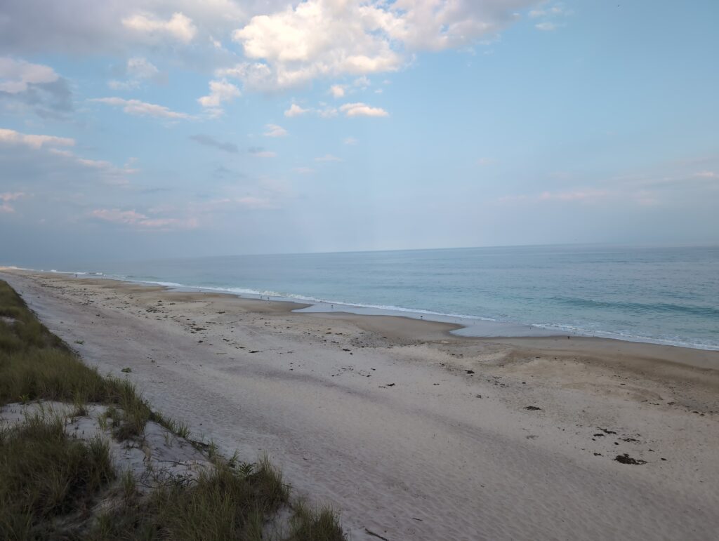 a sandy beach with waves crashing on it (MyCoast AI)