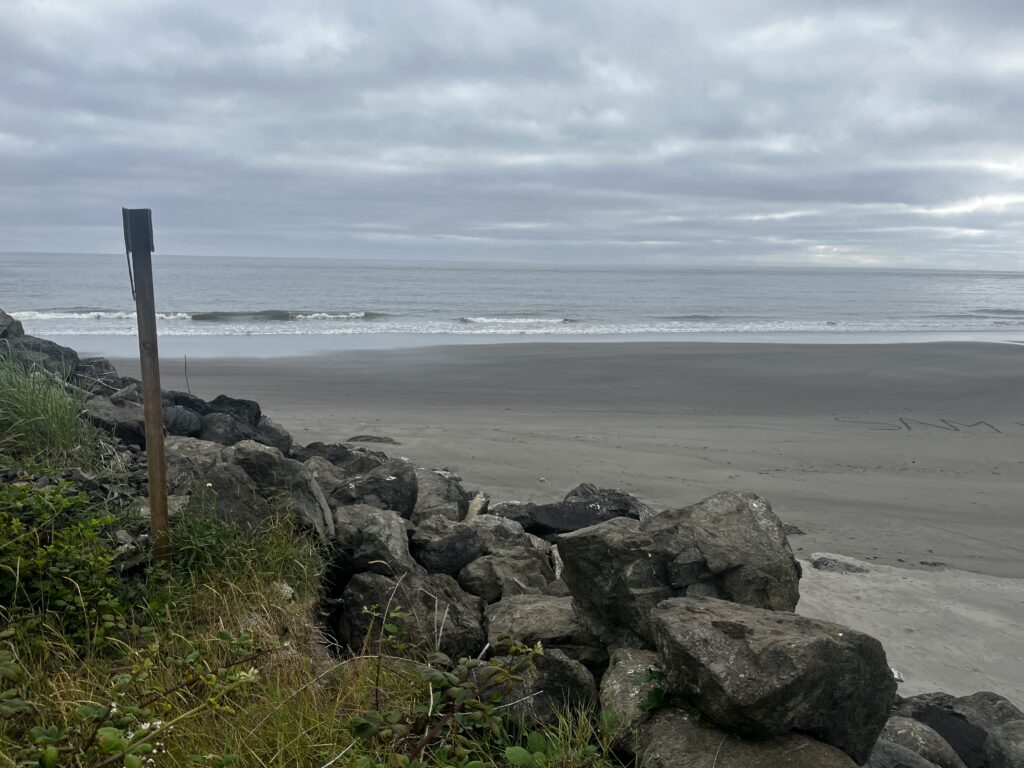 a rocky beach with a sign (MyCoast AI)