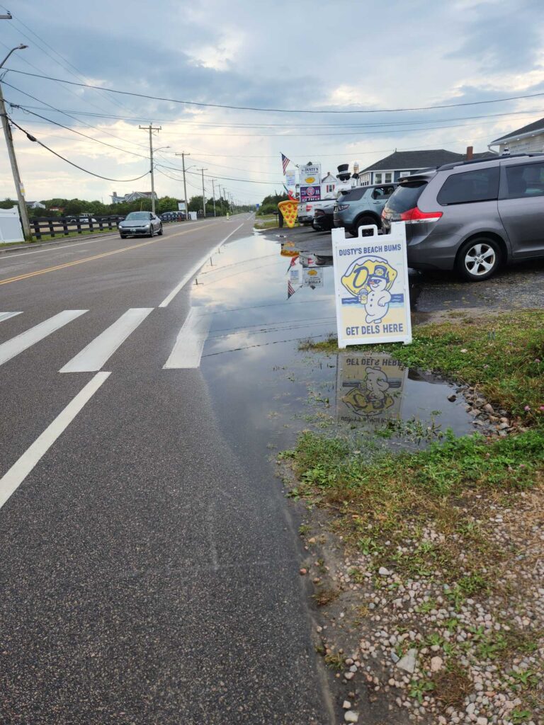 a road with cars and a sign (MyCoast AI)