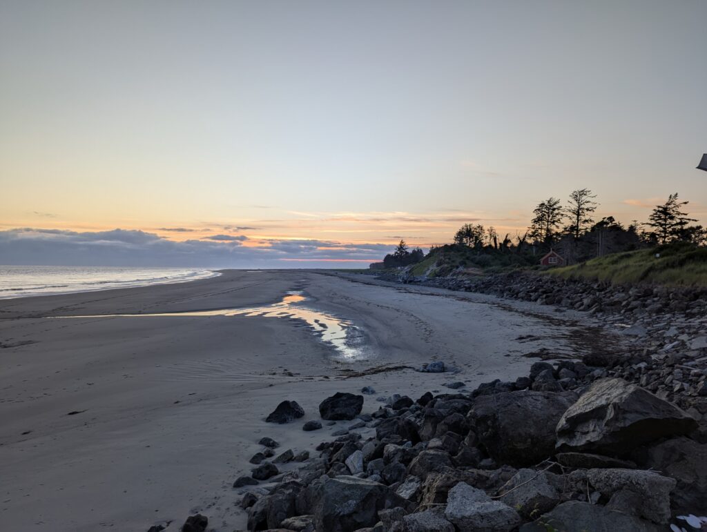 a rocky beach with a sunset (MyCoast AI)