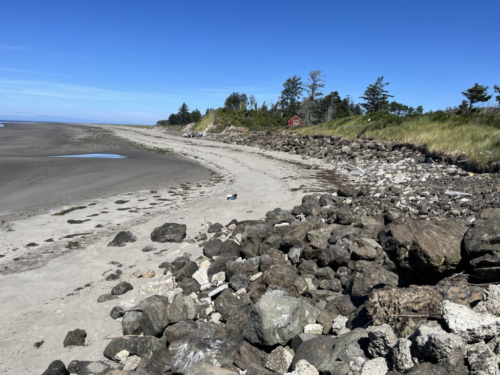 a rocky beach with a small house (MyCoast AI)