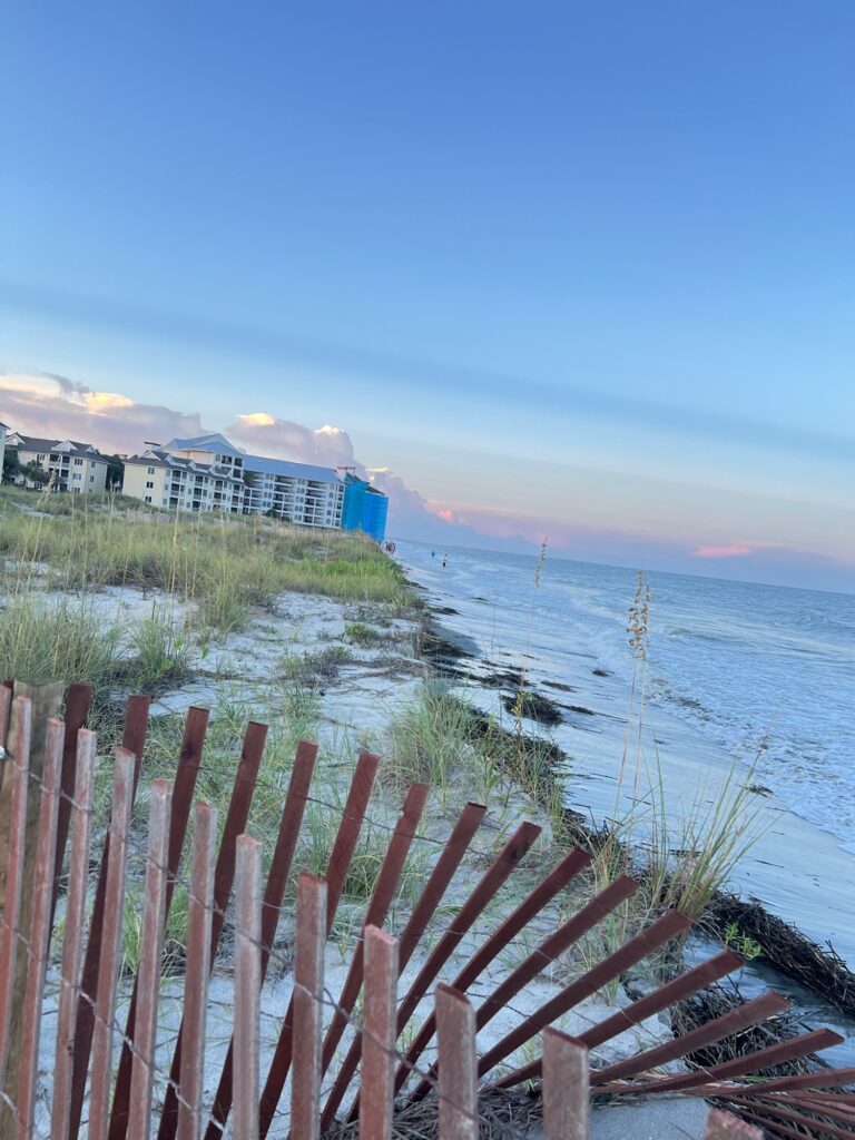 a wooden fence on a beach (MyCoast AI)