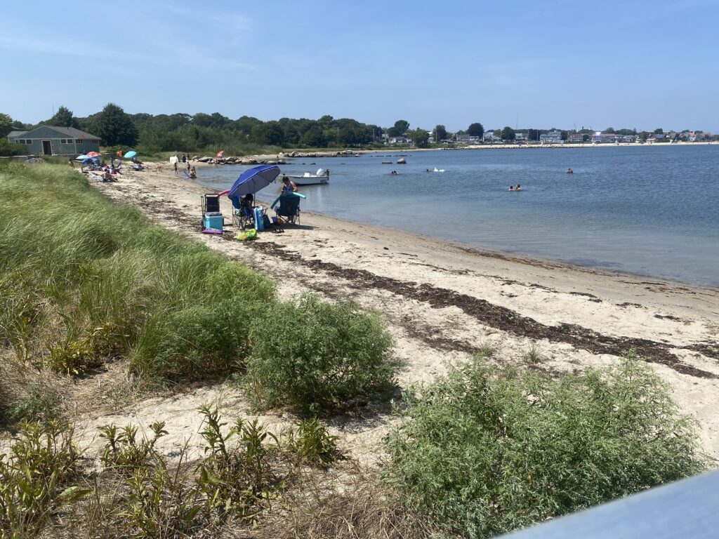 a beach with people and tents (MyCoast AI)