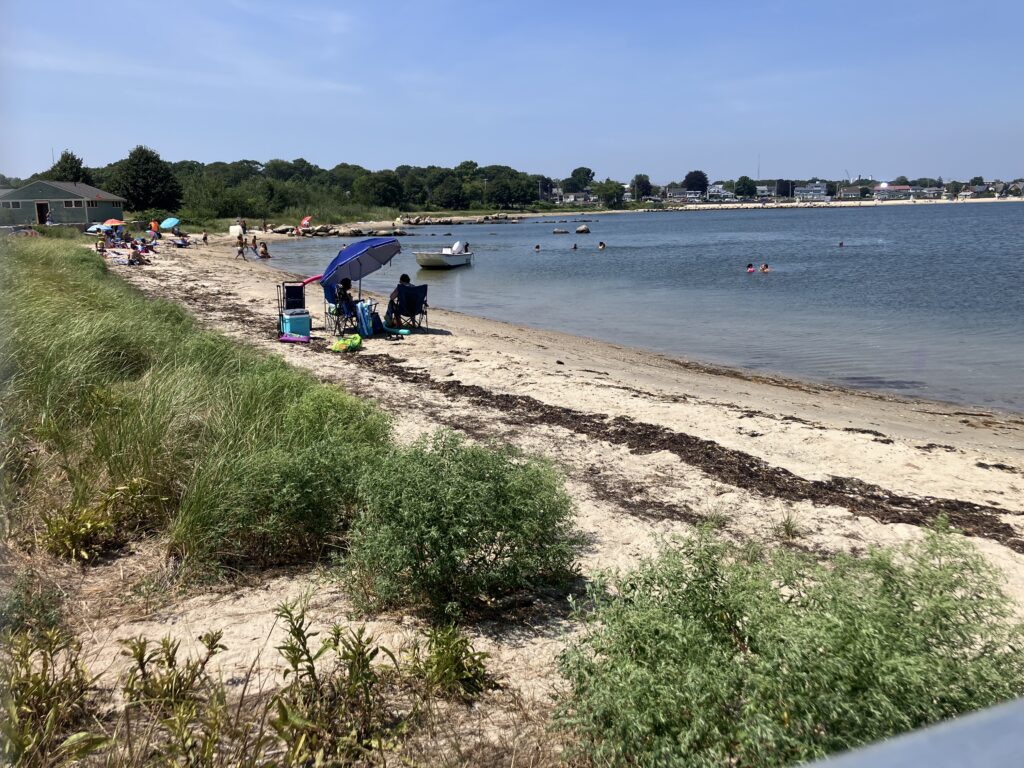 a beach with people and tents (MyCoast AI)