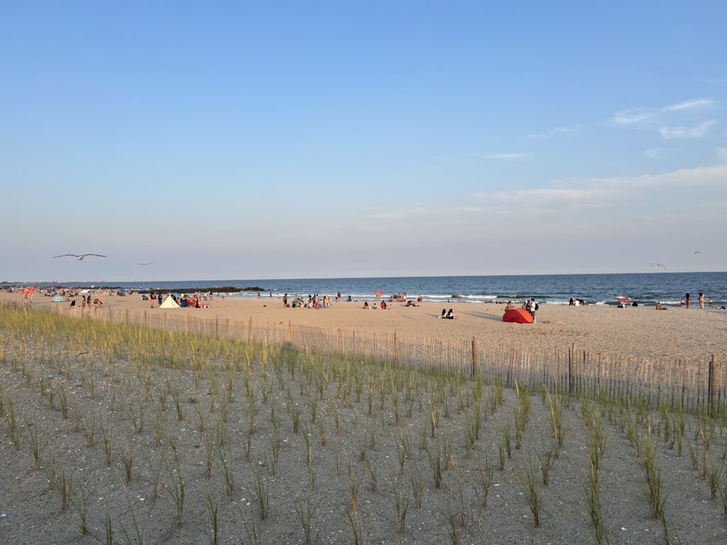 a beach with people and tents (MyCoast AI)