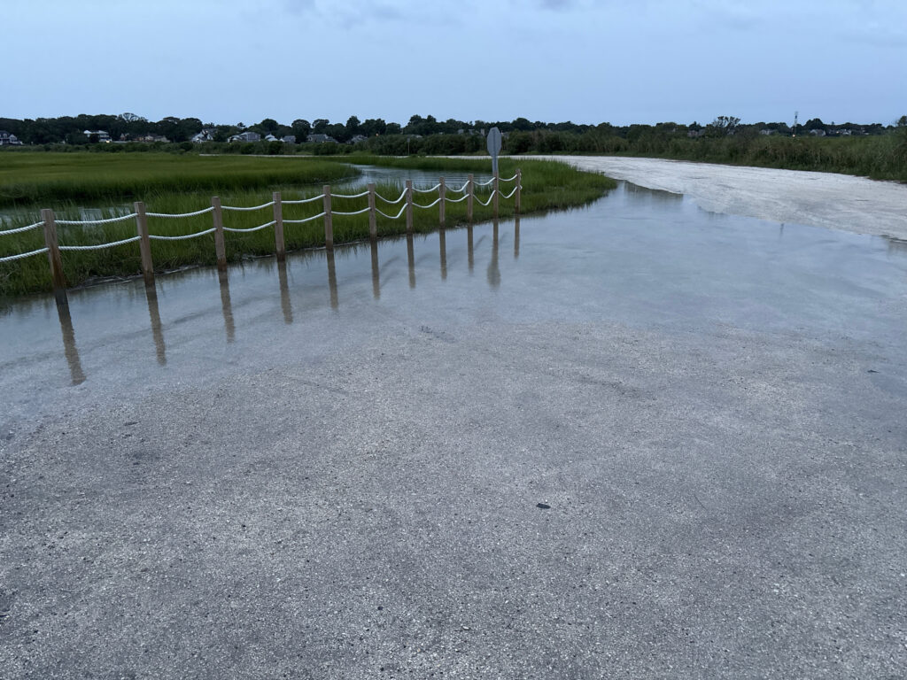 a body of water with a fence and grass around it (MyCoast AI)