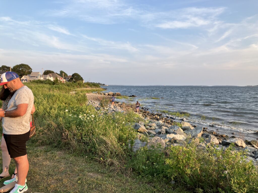 a man walking on a path by a body of water (MyCoast AI)